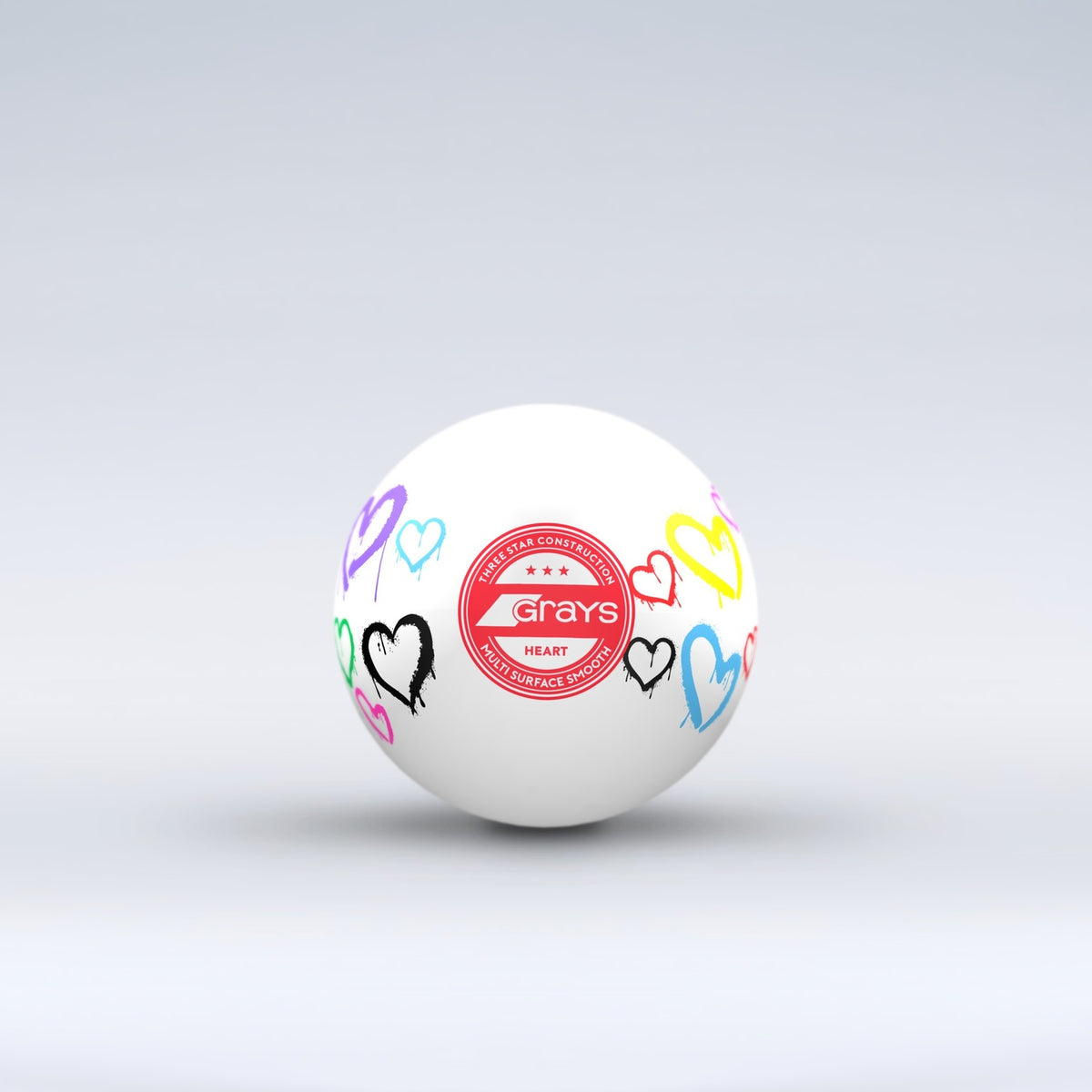 The Grays Novelty Hockey Ball 2026 features a white design with three-star construction, a red central logo, and colorful heart graphics—an eye-catching choice for any hockey player.