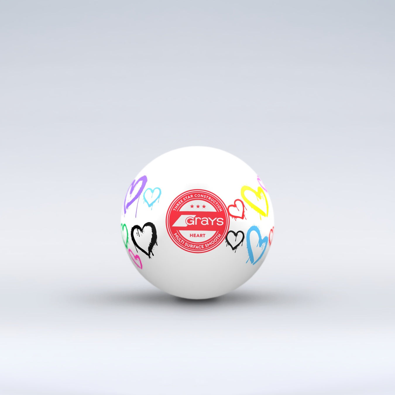 The Grays Novelty Hockey Ball 2026 features a white design with three-star construction, a red central logo, and colorful heart graphics—an eye-catching choice for any hockey player.