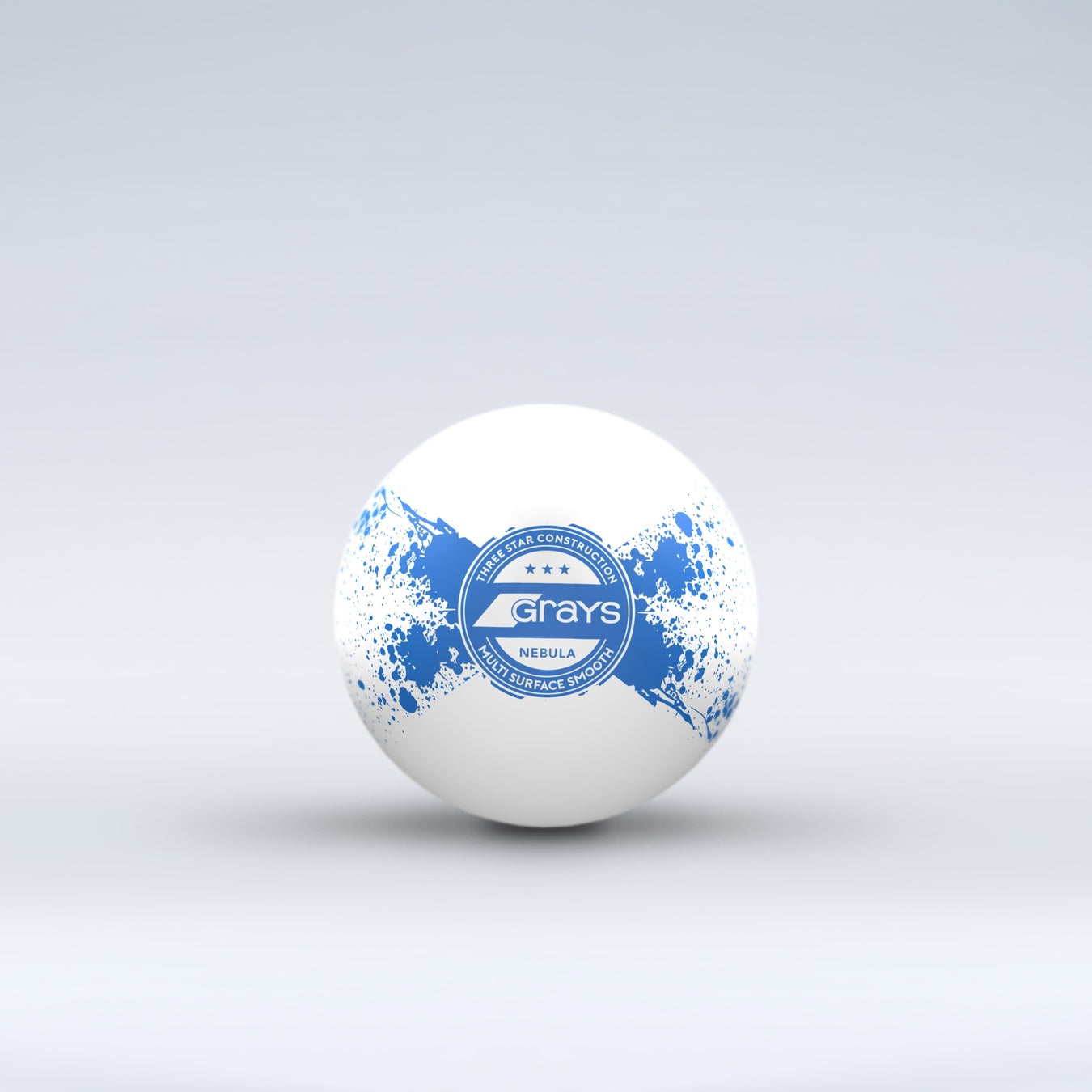 The Grays Novelty Hockey Ball 2026 is a white ball with blue paint splatter, a central circular Grays logo, and durable 3 star construction, shown against a light gray background.