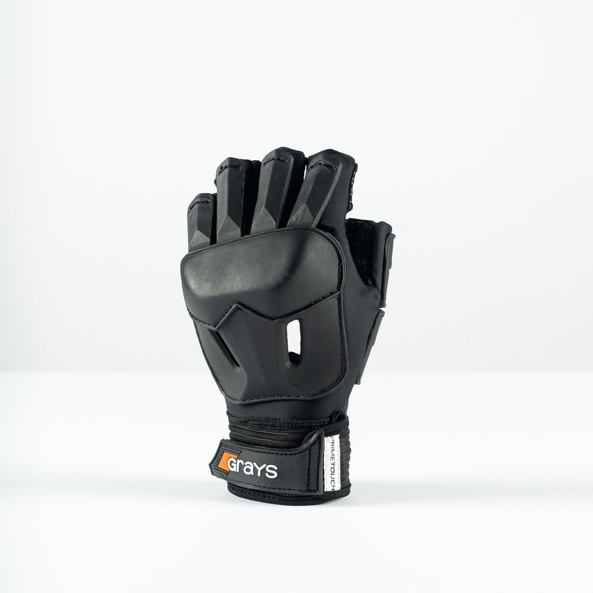 The Grays Prime Touch Hockey Glove, a black half-finger design with reinforced finger and knuckle padding and a “Grays” logo on the wrist strap, stands upright against a plain white background.