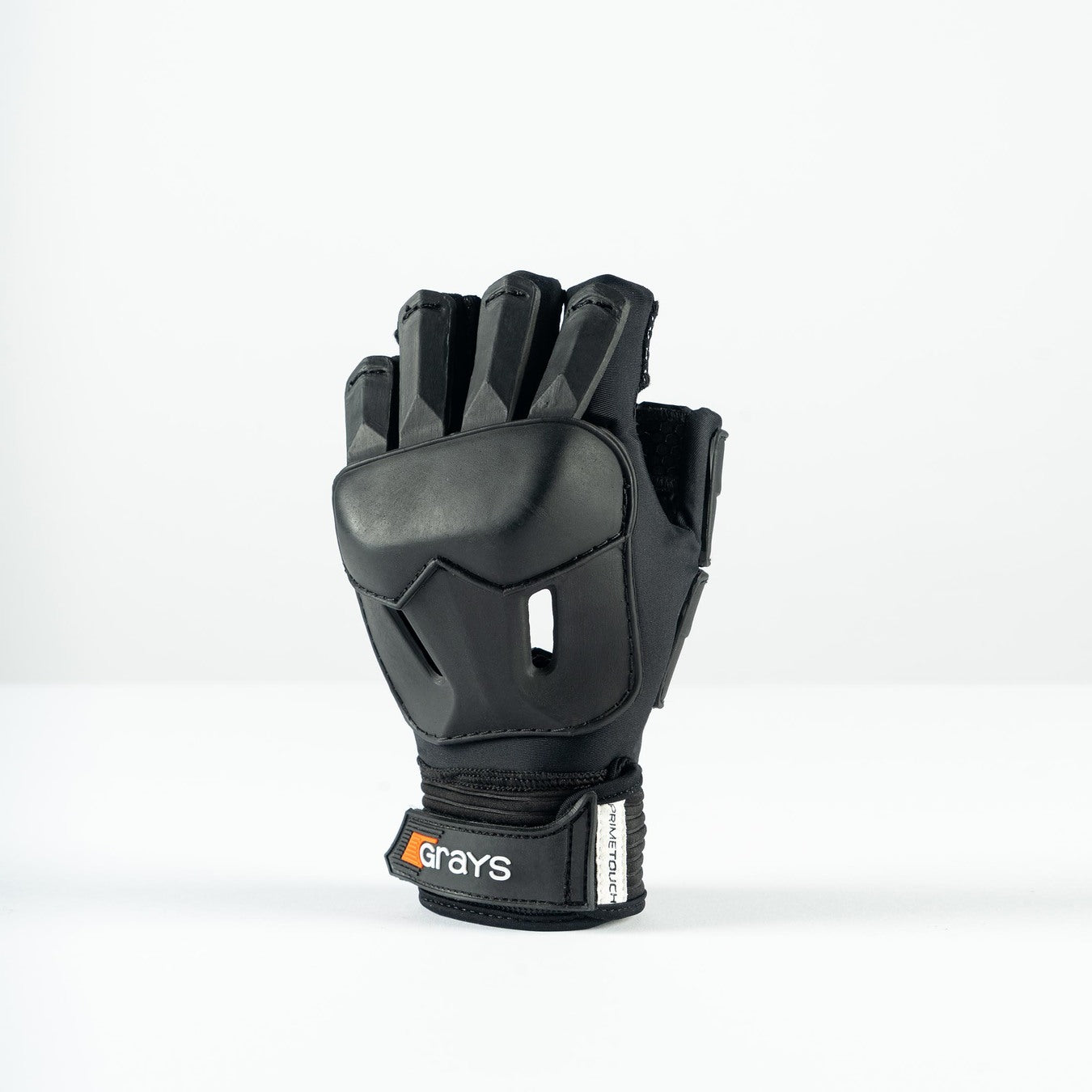 The Grays Prime Touch Hockey Glove, a black half-finger design with reinforced finger and knuckle padding and a “Grays” logo on the wrist strap, stands upright against a plain white background.