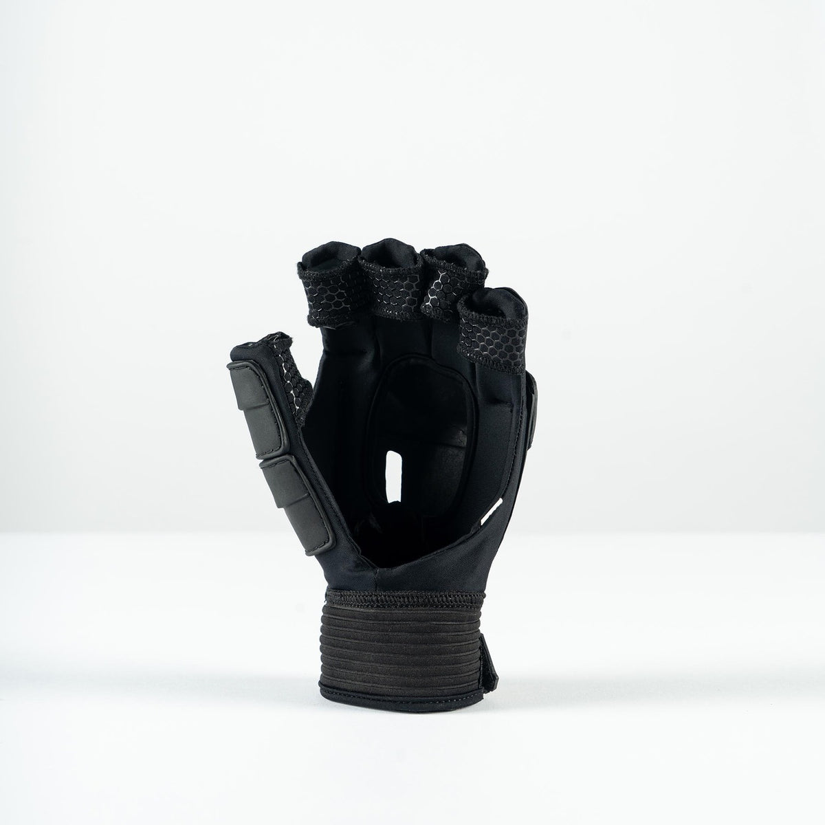 The Grays Prime Touch Hockey Glove by Grays is a black fingerless glove with padded knuckles, FlexShell armour, and a wide wrist strap, shown standing upright on a plain white surface.