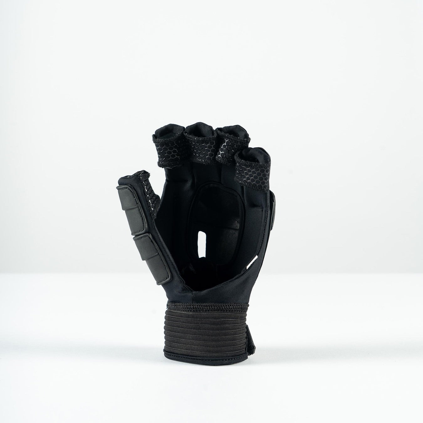 The Grays Prime Touch Hockey Glove by Grays is a black fingerless glove with padded knuckles, FlexShell armour, and a wide wrist strap, shown standing upright on a plain white surface.