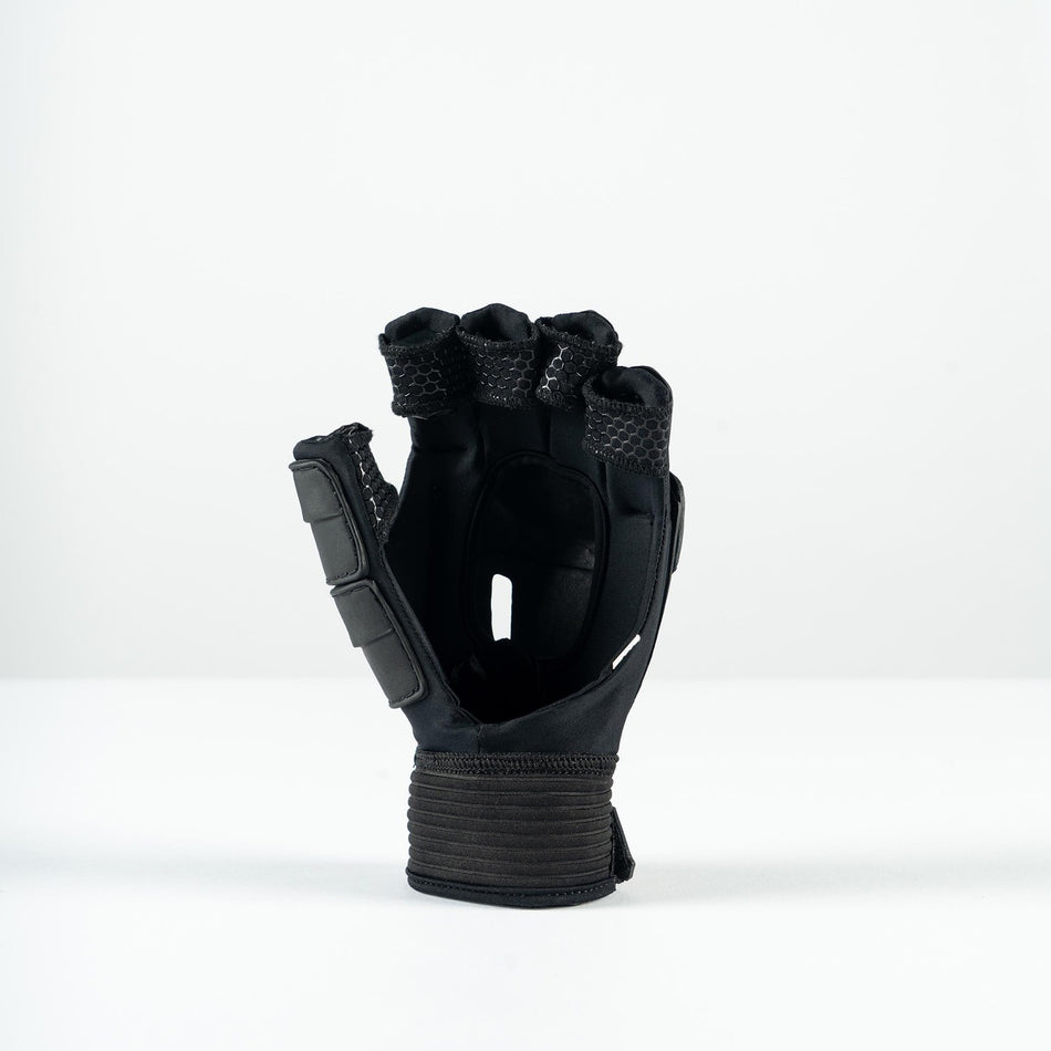 The Grays Prime Touch Hockey Glove by Grays is a black fingerless glove with padded knuckles, FlexShell armour, and a wide wrist strap, shown standing upright on a plain white surface.