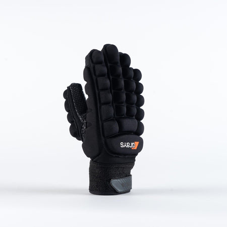The Grays International Pro Hockey Glove by Grays, in black, is shown standing upright on a plain white background. It features a lycra palm, thick segmented cushioning on the back, Velcro wrist strap, and an orange and white logo.