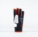 The Grays International Pro Hockey Glove by Grays is a black and white, full-finger glove with orange accents. It stands upright on a plain white background and features a lycra palm with textured, padded sections for grip and protection.