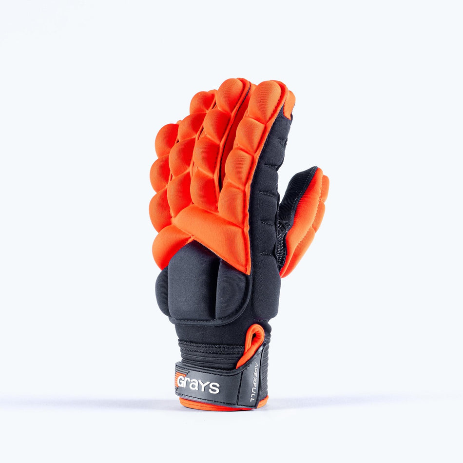A single red Grays Apex Full Hockey Glove stands upright with the palm facing left, featuring heavy knuckle padding, EVA Foam construction, and a wrist strap labeled "Grays.