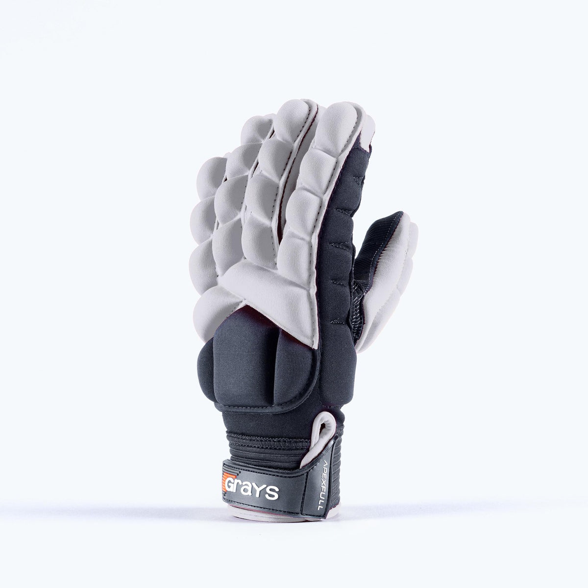 A padded, white Grays Apex Full Hockey Glove with segmented EVA Foam construction stands upright. The wrist strap shows the Grays brand and part of the label.