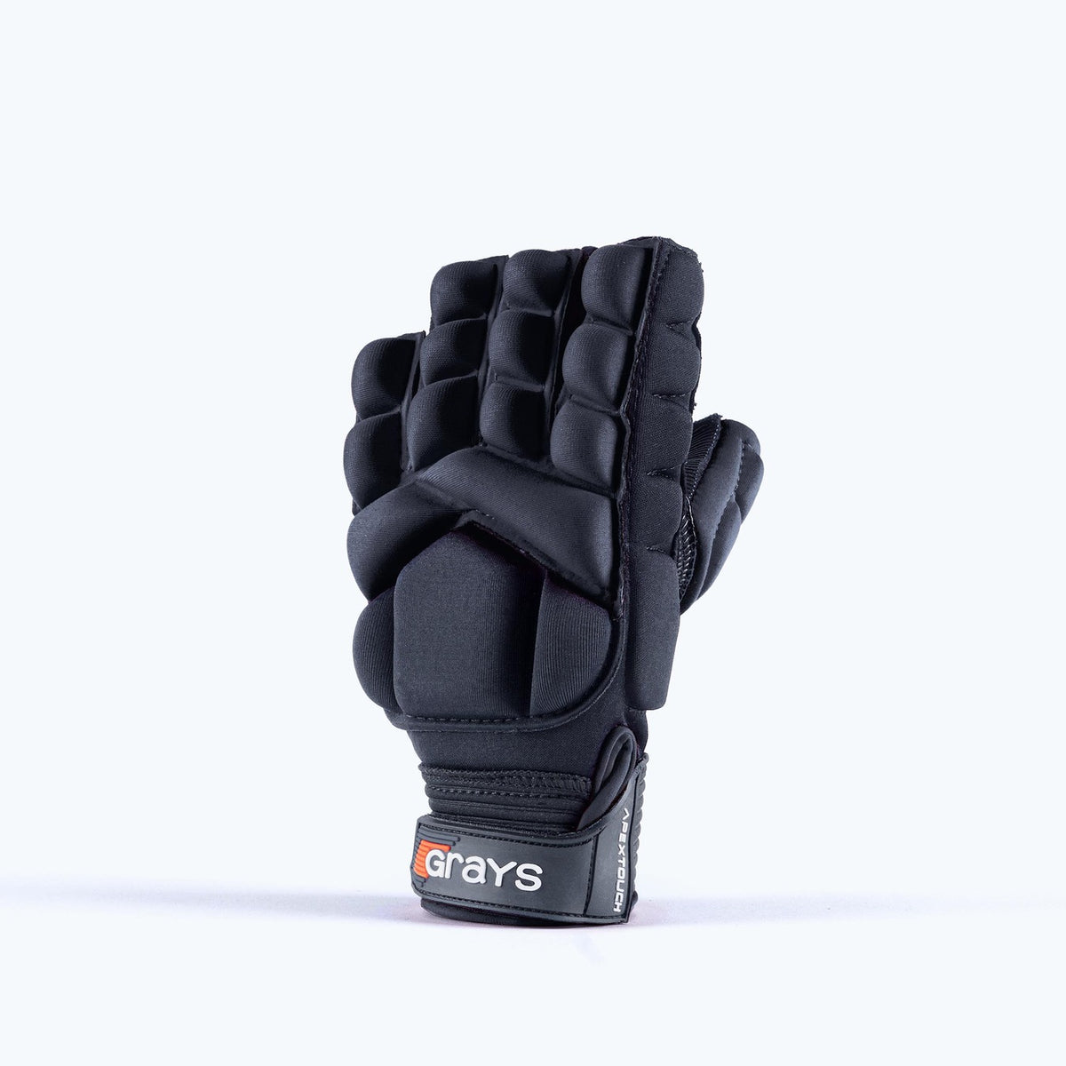 The Grays Apex Touch Hockey Glove is a black, padded half-finger sports glove with finger and knuckle protection, all-weather grip, and a wrist strap featuring the Grays brand name. Shown upright with the palm facing backward.