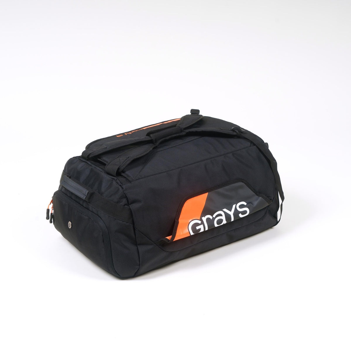 The Grays Omega Gen 3 Holdall is a black hockey bag with orange and white accents, featuring the Grays logo on the side, a handy shoe pocket, and is displayed against a plain white background.