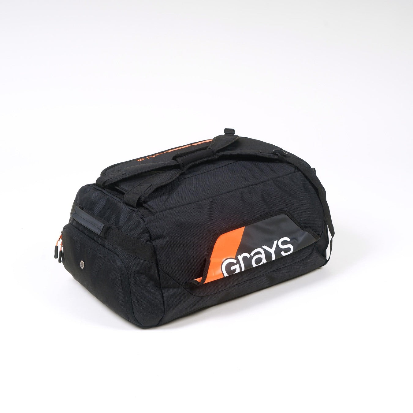 The Grays Omega Gen 3 Holdall is a black hockey bag with orange and white accents, featuring the Grays logo on the side, a handy shoe pocket, and is displayed against a plain white background.