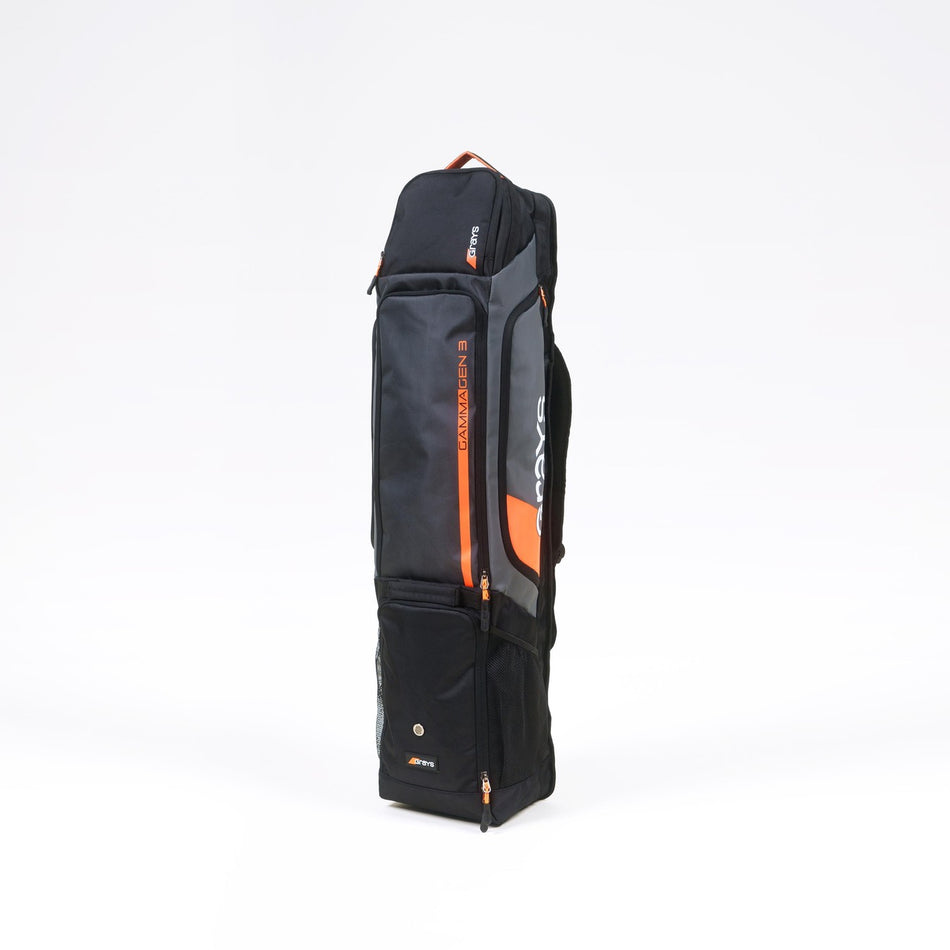 The Grays Gamma Gen3 Hockey Kitbag by Grays is a black rectangular sports bag with multiple zippered compartments, including a sticks compartment and carrying handle, shown standing upright on a plain white background.