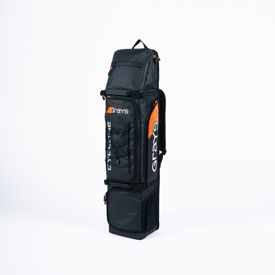 The Grays Cyclone WP Kitbag is a large black waterproof hockey bag with orange accents, multiple storage compartments, and "CYCLONE" printed vertically on the front, standing upright against a plain white background.