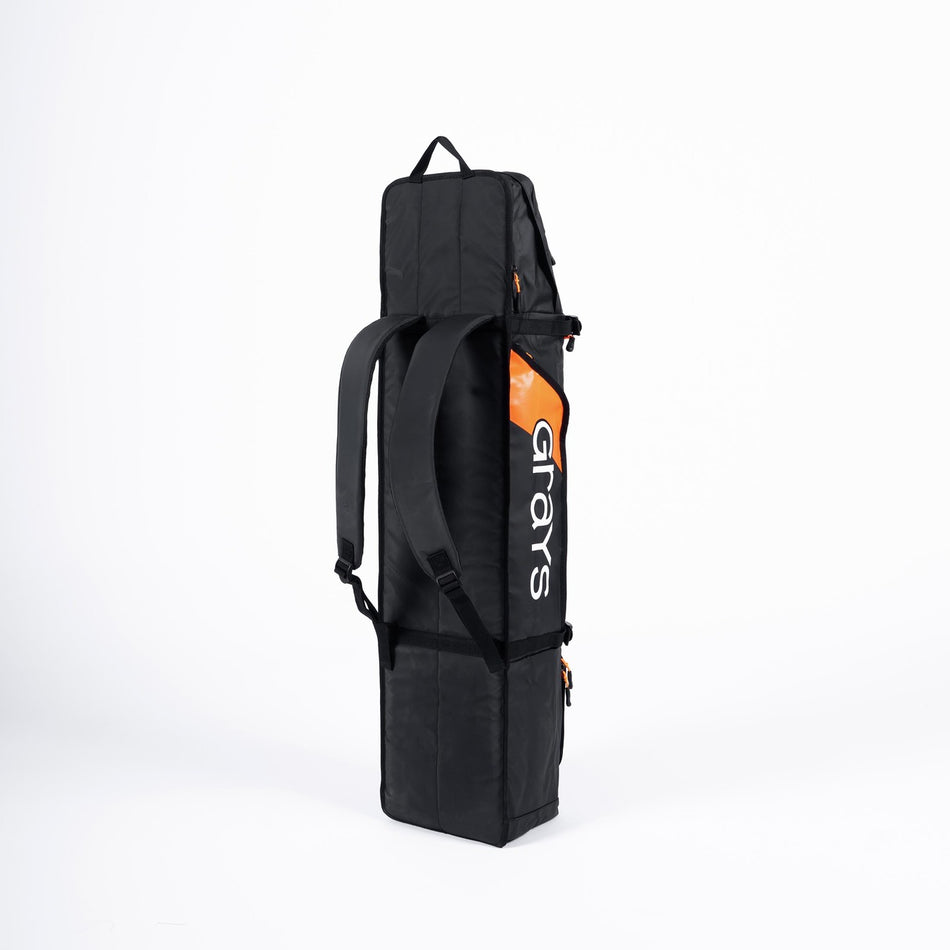 The Grays Cyclone WP Kitbag is a black waterproof hockey bag with two shoulder straps, standing upright. "Grays" appears in white on an orange background on the side. Perfect for kit storage, photographed against a plain white backdrop.