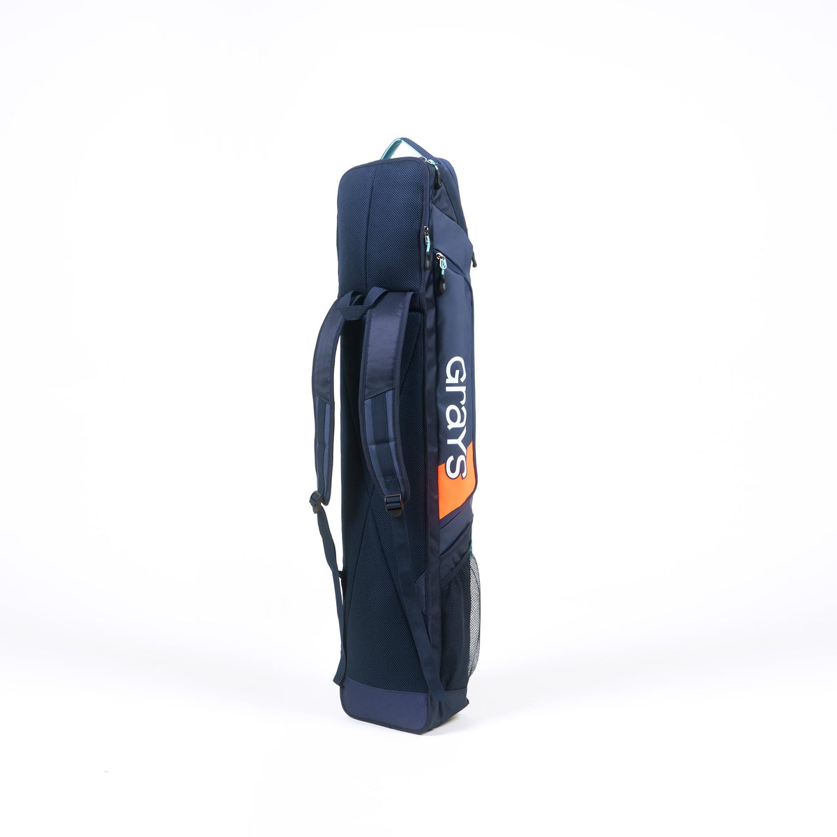 The Grays Delta Gen3 Hockey Kitbag by Grays, in navy blue with orange accents, features shoulder straps, a padded stick section, side pocket, and top handle; it stands upright against a white background.