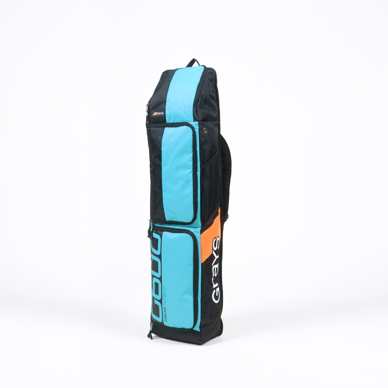 The Grays G600 Hockey Kitbag, in black and turquoise with orange accents, features multiple compartments, a padded strap, and Grays branding on the side. The bag stands upright against a white background.