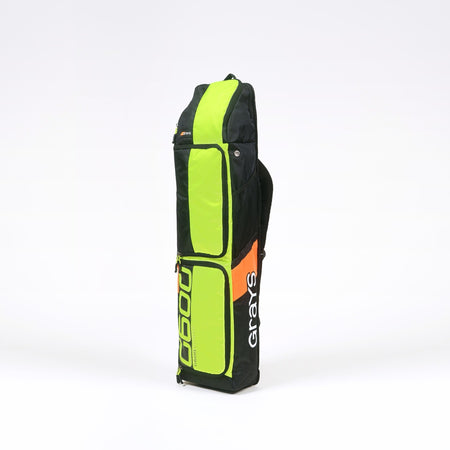 The Grays G600 Hockey Kitbag is a tall, rectangular bag in black, neon green, and orange panels, featuring "Grays" and "G6000" text. It offers multiple zippered compartments, a padded strap for comfort, a top handle, and water-repellent fabric.