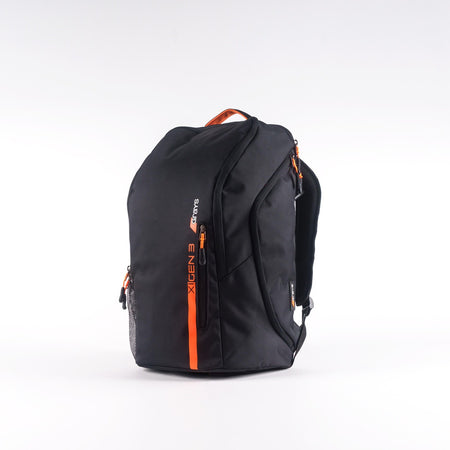 The Grays XI Gen 3 Rucksack by Grays is black with orange zippers and accents, a top handle, mesh side pocket, padded laptop pocket, and XGEN 3 branding on the front, shown against a plain white background.