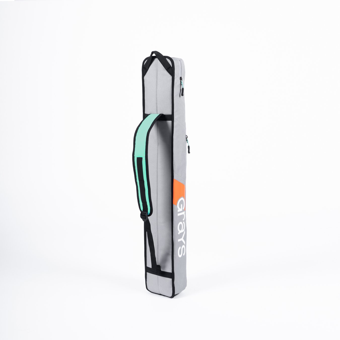 The Grays G100 Hockey Stick Bag is a light gray rectangular kit bag with black edges, a mint green and black single strap, and "Grays" in white and orange on the side. It features a stick section and stands upright against a white background.