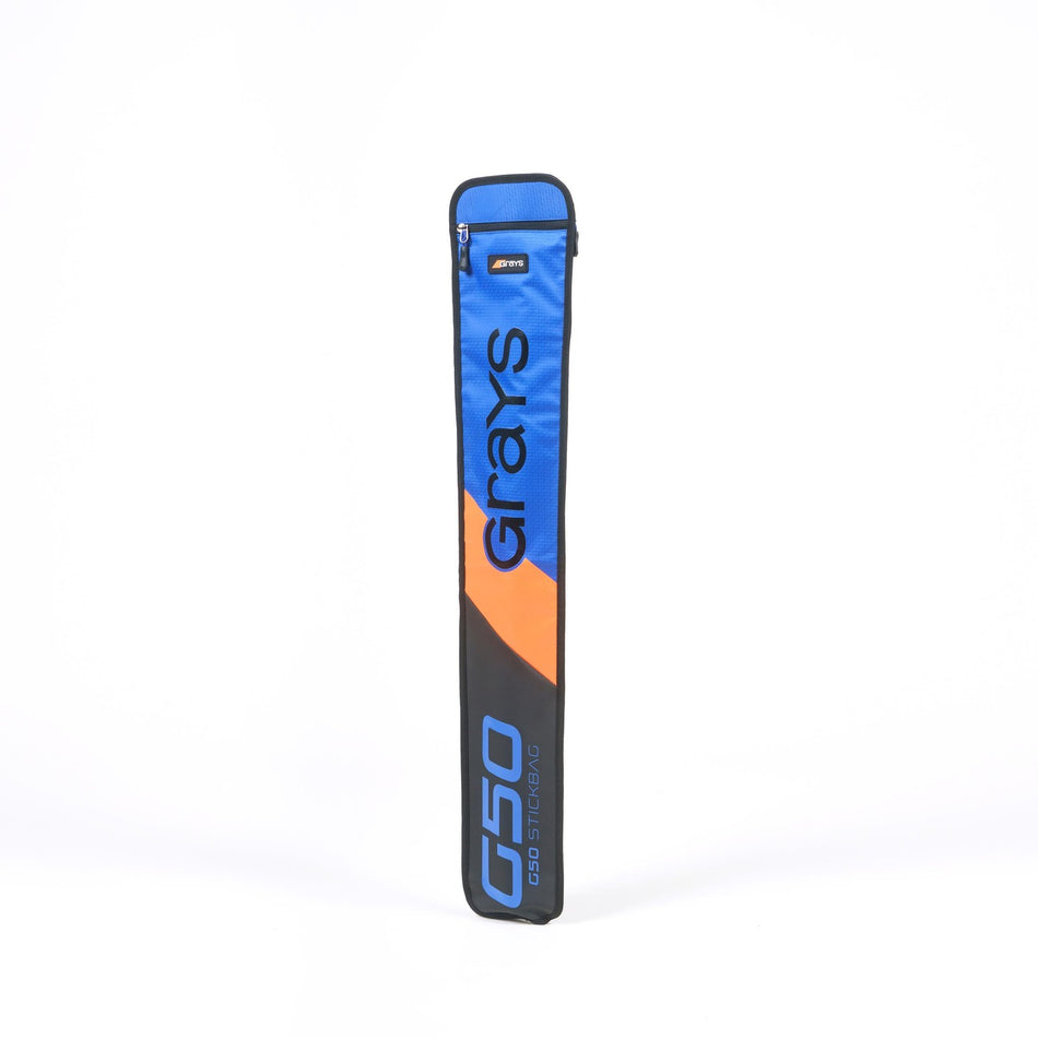 The Grays G50 Stick Bag in blue, black, and orange stands upright against a white background with bold Grays branding, an adjustable strap for comfort, and a top zipper pocket.