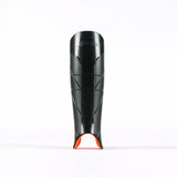 A black Grays Hockey G900 Shinguard with small ventilation slits and an orange accent at the bottom, made from advanced flexible polymer for top protection, stands upright on a white background.