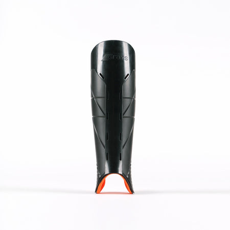 A black Grays Hockey G900 Shinguard with small ventilation slits and an orange accent at the bottom, made from advanced flexible polymer for top protection, stands upright on a white background.