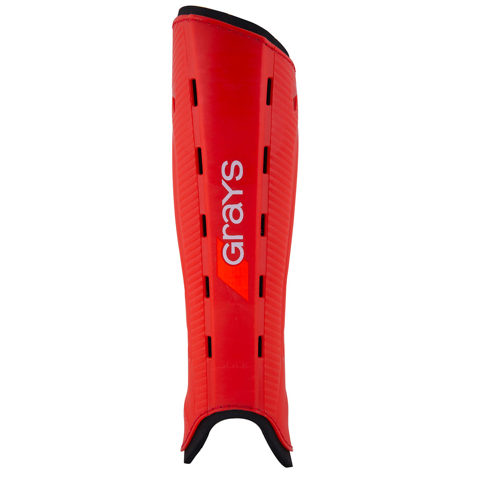 The Grays G600 Hockey Shinguard features a red and black design with ventilation slits, the Grays logo in white and orange, and a lightweight polymer shell for excellent impact protection.