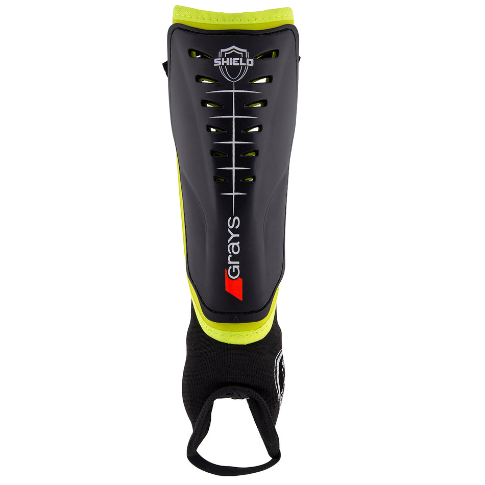 The Grays Shield Shinguard features a black/yellow design with the Shield logo, red accent, shock-absorbing material, and a protective ankle strap with padding for added comfort.