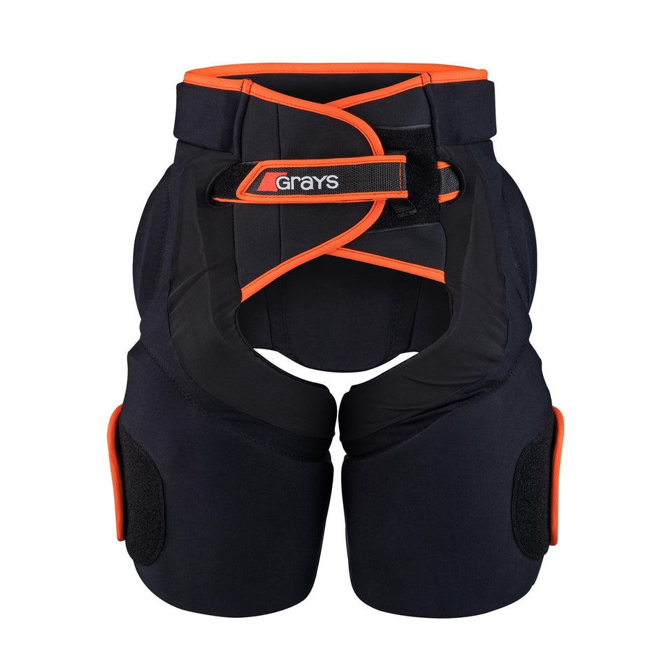 The Grays Elite Padded GK Shorts feature black padding, orange trim, velcro straps, and high-density foam armor for impact protection in goalie sports. The Grays brand name is displayed on the front closure.