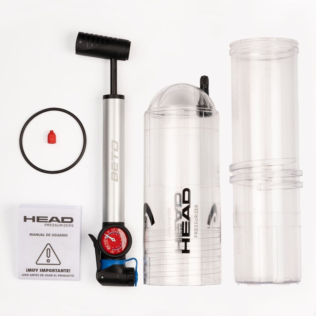 A Head X4 Pump Ball Pressuriser by Head, featuring a gauge, black O-ring, red valve cap, instruction manual, and two clear cylindrical pressure chambers arranged neatly on a white background.