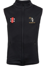The Gray Nicolls Hillesley CC Black Storm Bodywarmer is a sleeveless micro-fleece vest with a front zipper, two zippered pockets, and small cricket-themed embroidered logos in red, white, and yellow on the left chest.