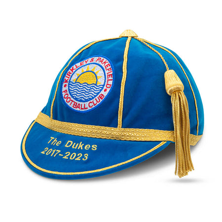 A blue and gold velvet honour cap with tassel, featuring an embroidered Kirkley & Pakefield FC crest and "The Dukes 2017-2023" in gold—part of Martin Berrill Sports' Custom, Honour & Commemorative Caps collection.
