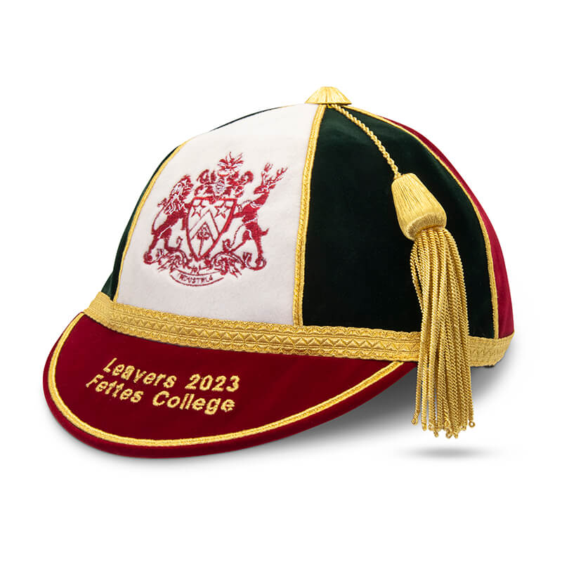 The Martin Berrill Sports Custom Honour & Commemorative Cap features green, white, and red panels with gold trim and tassel, Leavers 2023 Fettes College embroidered on the brim, and a crest on the front for a special keepsake.