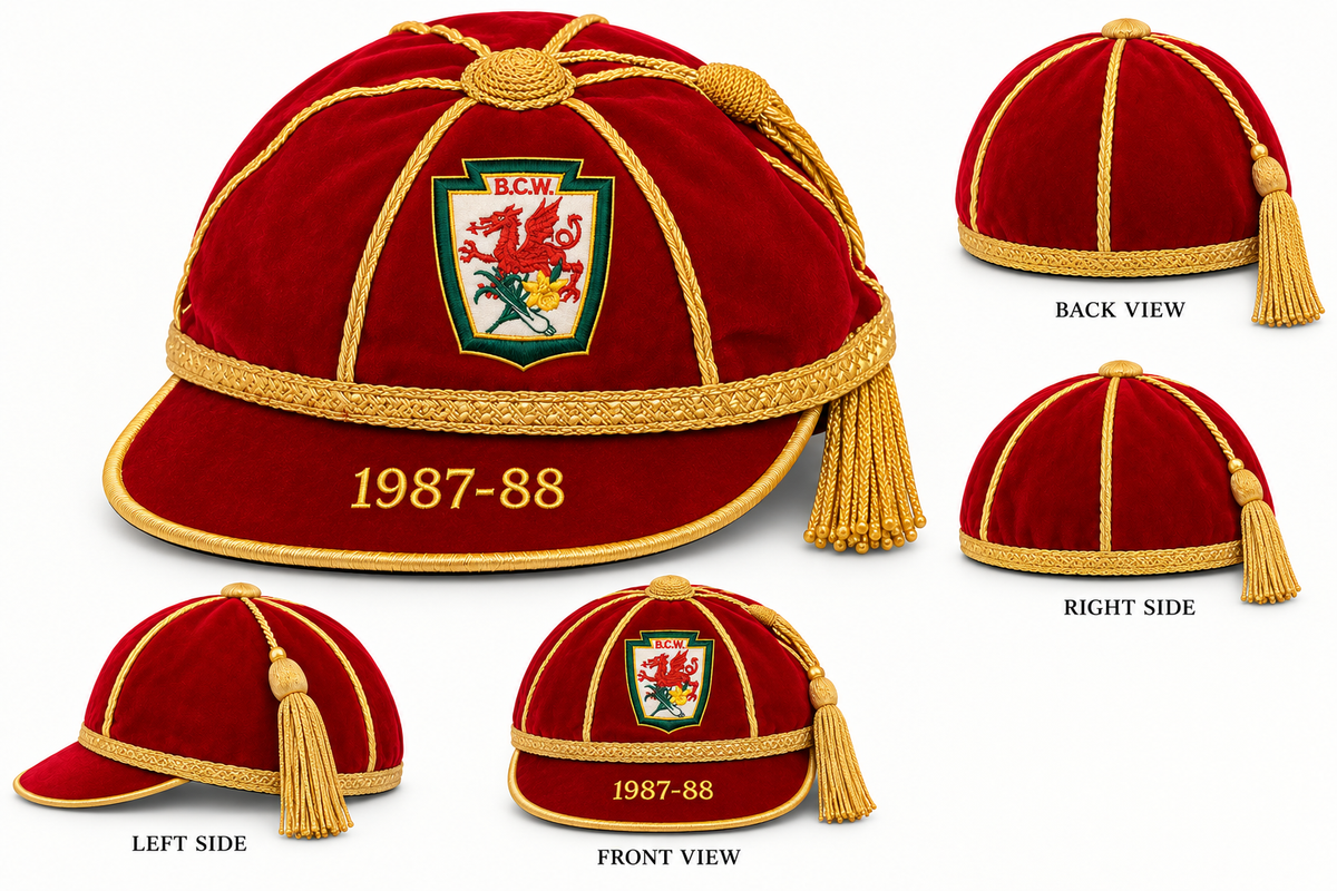 A Martin Berrill Sports Custom, Honour & Commemorative Cap in maroon velvet, featuring gold piping, a gold tassel, an embroidered red dragon crest, and 1987-88 on the brim, shown from multiple angles.