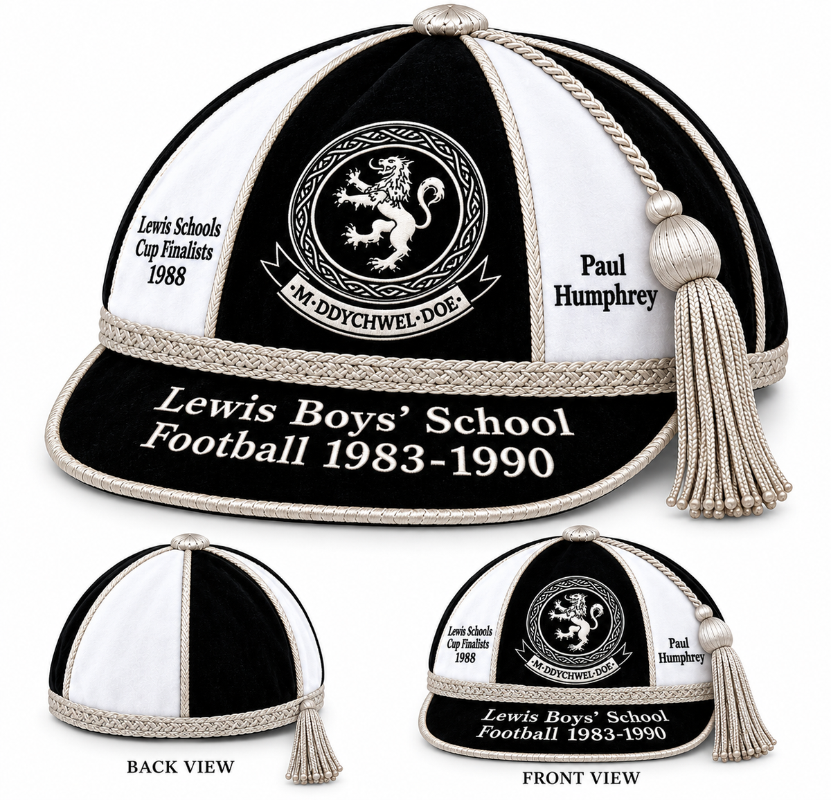Three views of a Custom, Honour & Commemorative Cap in black and white with silver piping, a tassel, and embroidery reading Lewis Boys School Football 1983-1990, Lewis Schools Cup Finalists 1988, and Paul Humphrey.