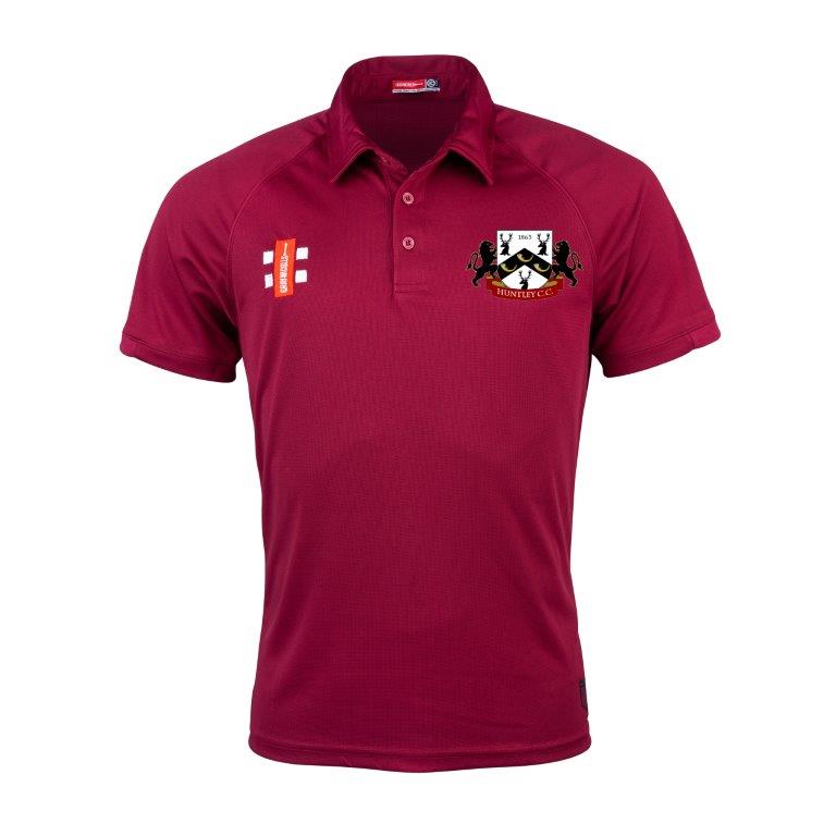 The Gray Nicolls Huntley CC Matrix V2 Maroon Polo is made for active training, with moisture-wicking fabric, a black and white lion crest on the left chest, and a white and orange logo on the right.