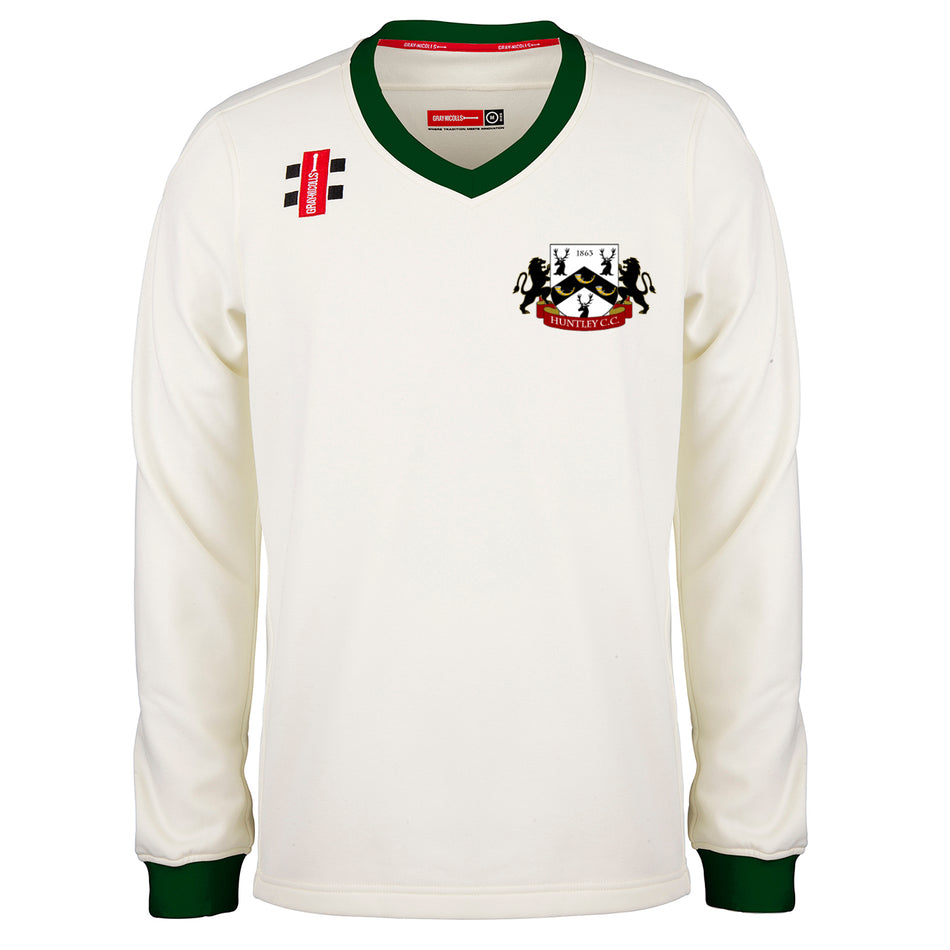 The Gray Nicolls Huntley CC Pro Performance Sweater (Adult) is a cream long-sleeve cricket sweater with green collar and cuffs, a red and black crest on the left chest, and two black bars above a red label on the right shoulder.