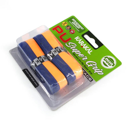 The Karakal PU Super Grip Duo, a pack of two orange and navy grips, comes sealed in clear plastic with a green and white label—perfect for adding comfort and durability to your racket.