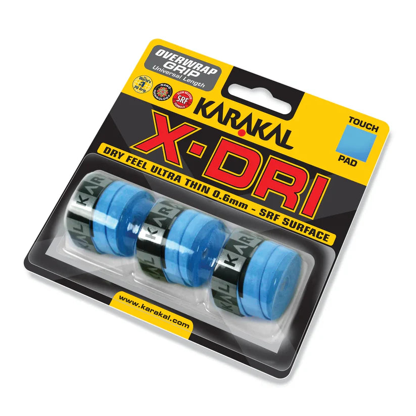 A pack of four blue Karakal X-DRI Overwrap Grips from Karakal is shown in clear packaging with yellow and black branding, featuring Dry Feel, ultra-thin 0.6mm design, and SRF Surface for superior grip performance.