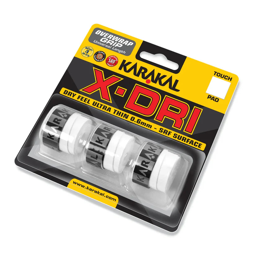 The Karakal X-DRI Overwrap Grip retail pack by Karakal includes three white, ultra-thin 0.6mm grips with SRF Surface for dry feel and comfort, displayed in a plastic case. "Dry Feel Ultra Thin" is featured on the packaging.