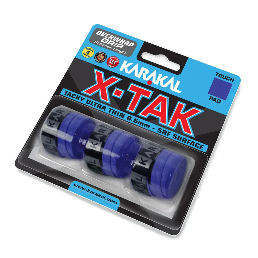 A pack of four blue Karakal X-TAK Overwrap Grips (0.6mm ultra-thin, tacky finish) for sports rackets, each with black bands, securely packed in clear plastic.