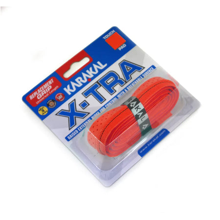 A Karakal X-TRA Grip for sports rackets, in red, comes coiled inside a clear blister pack with blue and white labeling, offering cushioned comfort and high-tack handling.