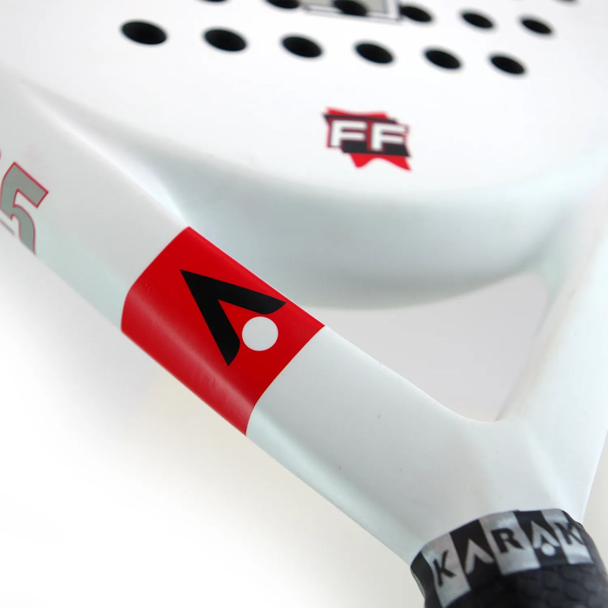 Close-up of the Karakal Padel FF 365 by Karakal, featuring a teardrop-shaped head, white face with red and black geometric logos, round perforations, and KARAKAL branding on the handle.