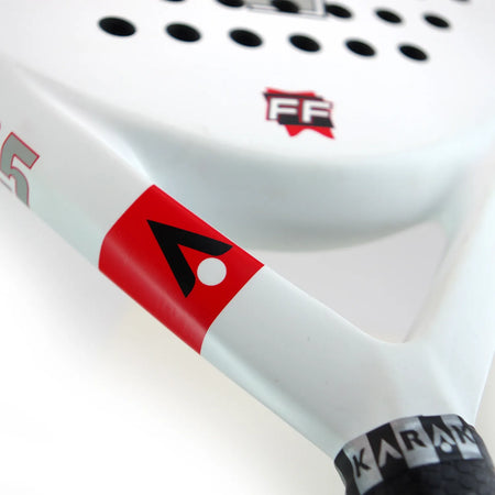 Close-up of the Karakal Padel FF 365 by Karakal, featuring a teardrop-shaped head, white face with red and black geometric logos, round perforations, and KARAKAL branding on the handle.