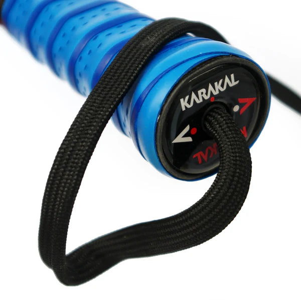Close-up of the end of a lightweight Karakal Air Lite 345 Padel - Blue racket handle with a black wrist strap and the Karakal logo on the end cap.
