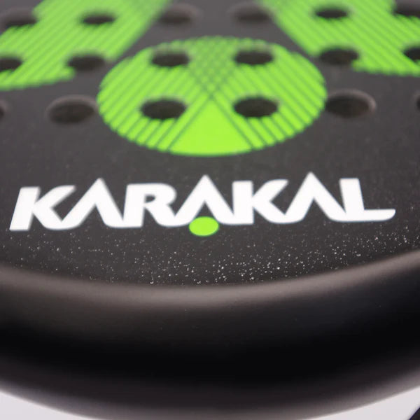 Close-up of the Karakal Air Lite 345 Padel - Green racket, made from lightweight graphite with green details, circular holes, and the KARAKAL brand name in bold white lettering.