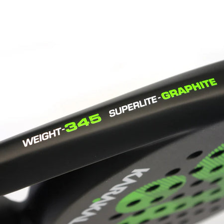 Close-up of the Karakal Air Lite 345 Padel - Green by Karakal, featuring a lightweight graphite frame with "WEIGHT-345 SUPERLITE-GRAPHITE" text in white and green, visible perforated holes, and part of a green pattern.