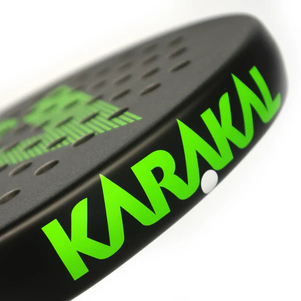 Close-up of the Karakal Air Lite 345 Padel - Green racket, made with lightweight graphite. The black surface has perforated holes, a partial graphic design, and the brand name Karakal in bright green along the edge.