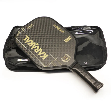The Karakal Pure Touch Gold Pickleball Paddle by Karakal features a black textured surface with a checkered pattern and gold lettering, shown resting atop its matching black zippered carrying case.