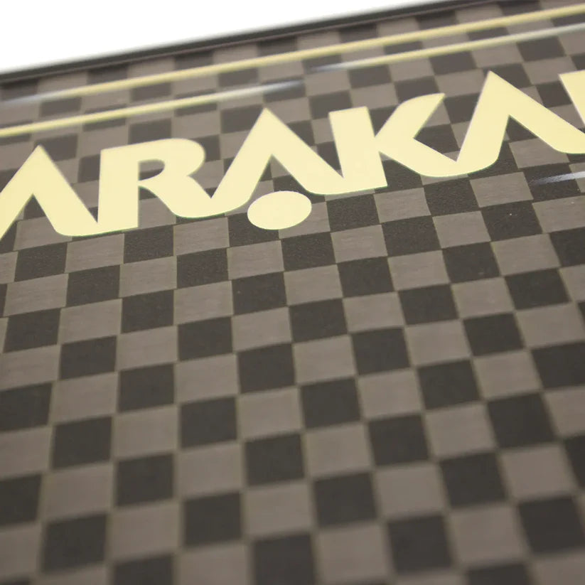 Close-up of the Karakal Pure Touch Gold Pickleball Paddle by Karakal, featuring a brown and black checkerboard pattern with part of the word "Karakal" in large cream-colored letters across the top.